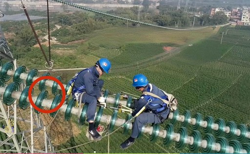 lineman on the glass insulator for powertower.jpg
